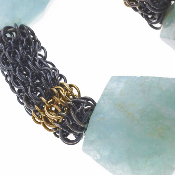 Detail of the oxidized Sterling silver and 18KY chain mail section where it meets an Aquamarine bead on the Glacier Necklace
