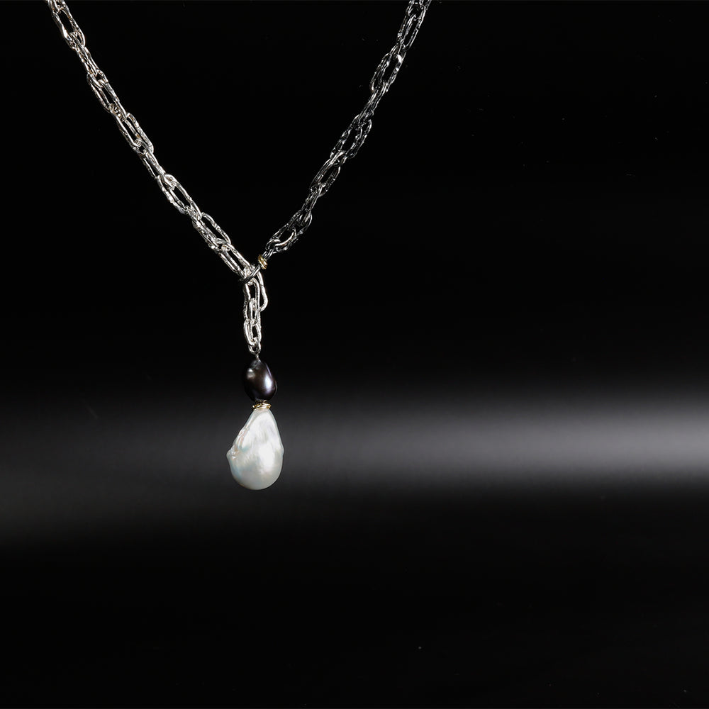 light and dark chain with a black and white pearl pendant
