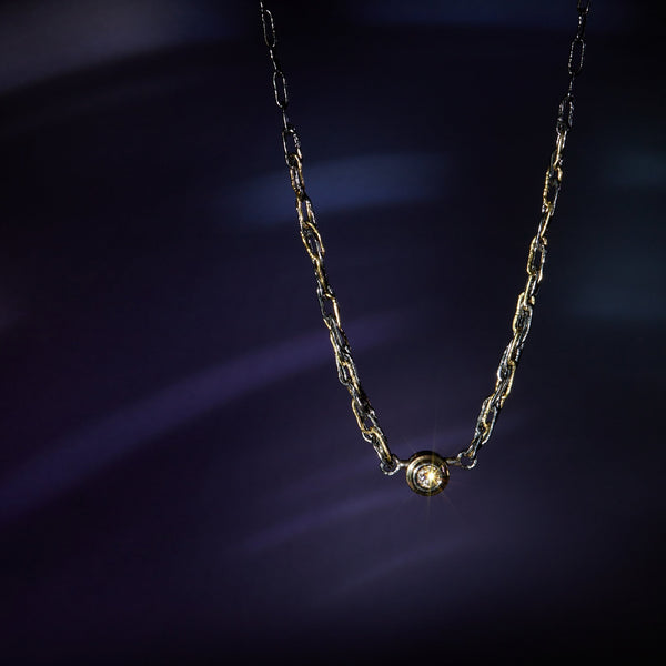 Black sterling silver and 18KY gold woven rope chain necklace with a bezel set round white natural diamond. 