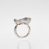 Side view of sterling silver ring with a large white freshwater pearl on the top