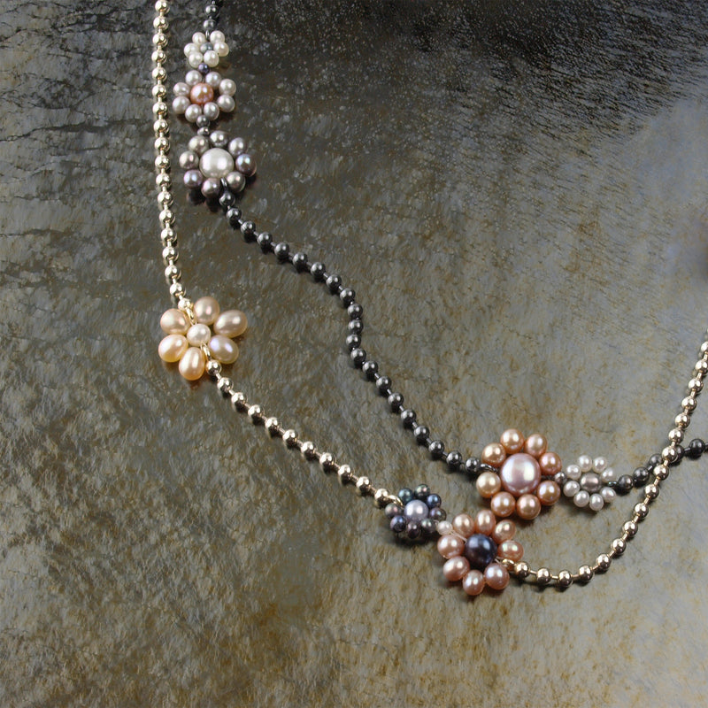 two beaded chain necklaces with freshwater pearl flowers, one is bright Sterling silver and the other is oxidized.