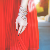 model wearing web bracelet with a red dress
