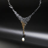 Distressed and oxidized sterling silver chainmail necklace with black and white freshwater pearls.