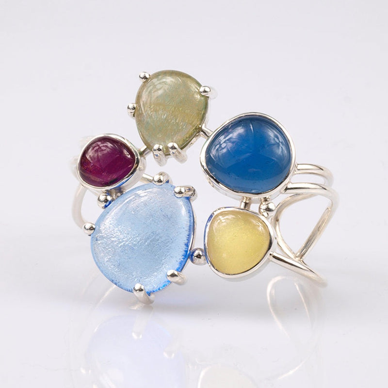 fused glass cabochons form a large flower in a sterling Silver cuff style bracelet