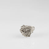 Sterling silver chain maille ring by Carolina Cole shown from the side.