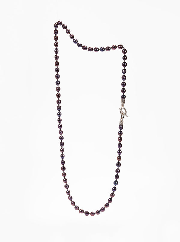 Long strand of black pearls with a silver toggle clasp on the side