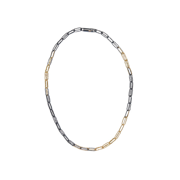 Interwoven links of distressed oxidized Sterling silver and 18KY gold make up this chain. There is a barrel type lock at the back.