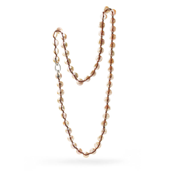 RANGE Freshwater pearl necklace made of large discs shaped pearls, strung on thin leather cord.. Carolina Cole.